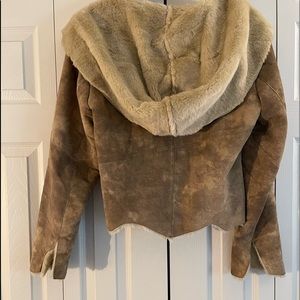 100% leather, distressed suede, rough cut hide appearance and faux fur interior.